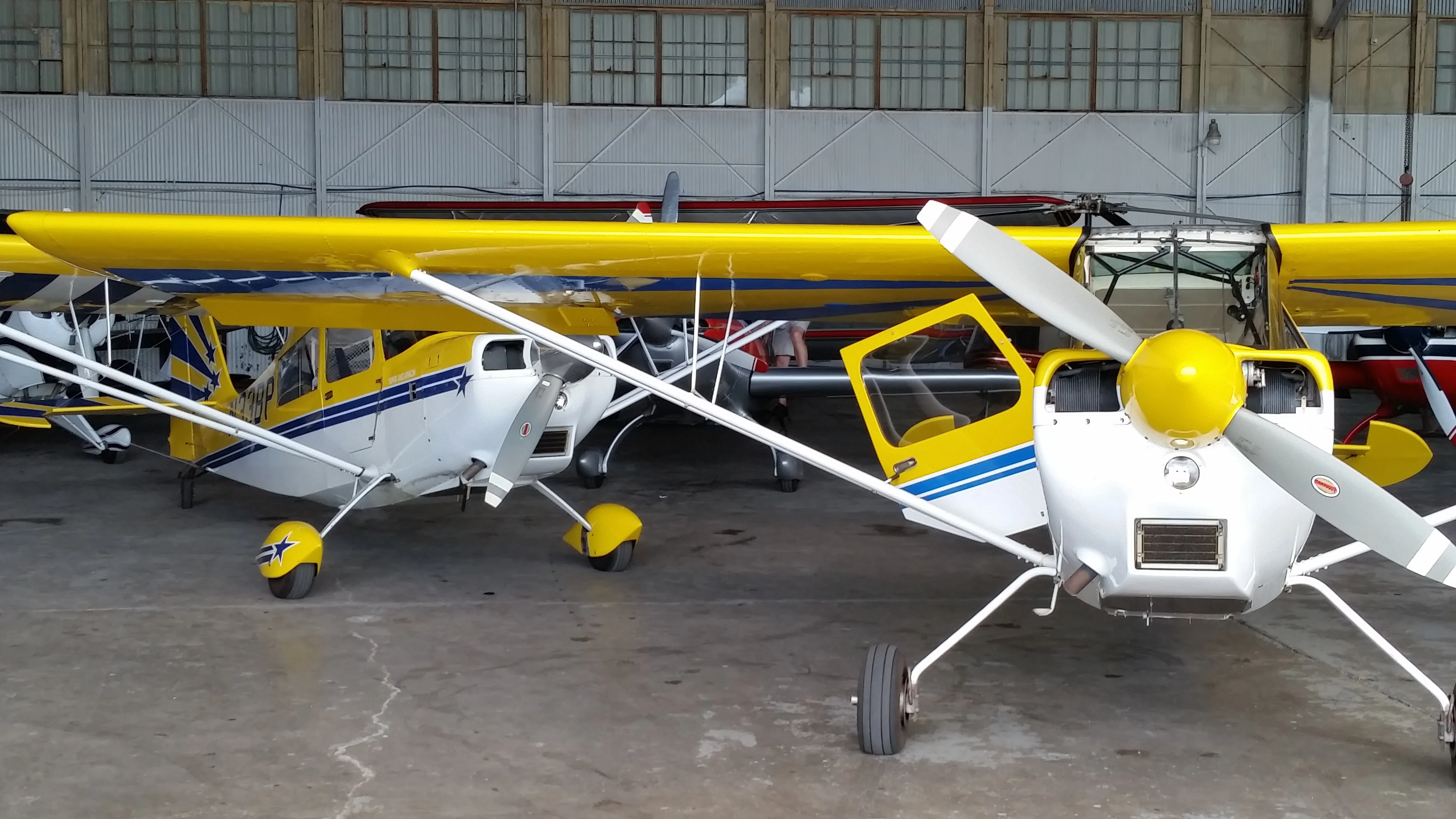 a couple of airplanes leaving a hangar