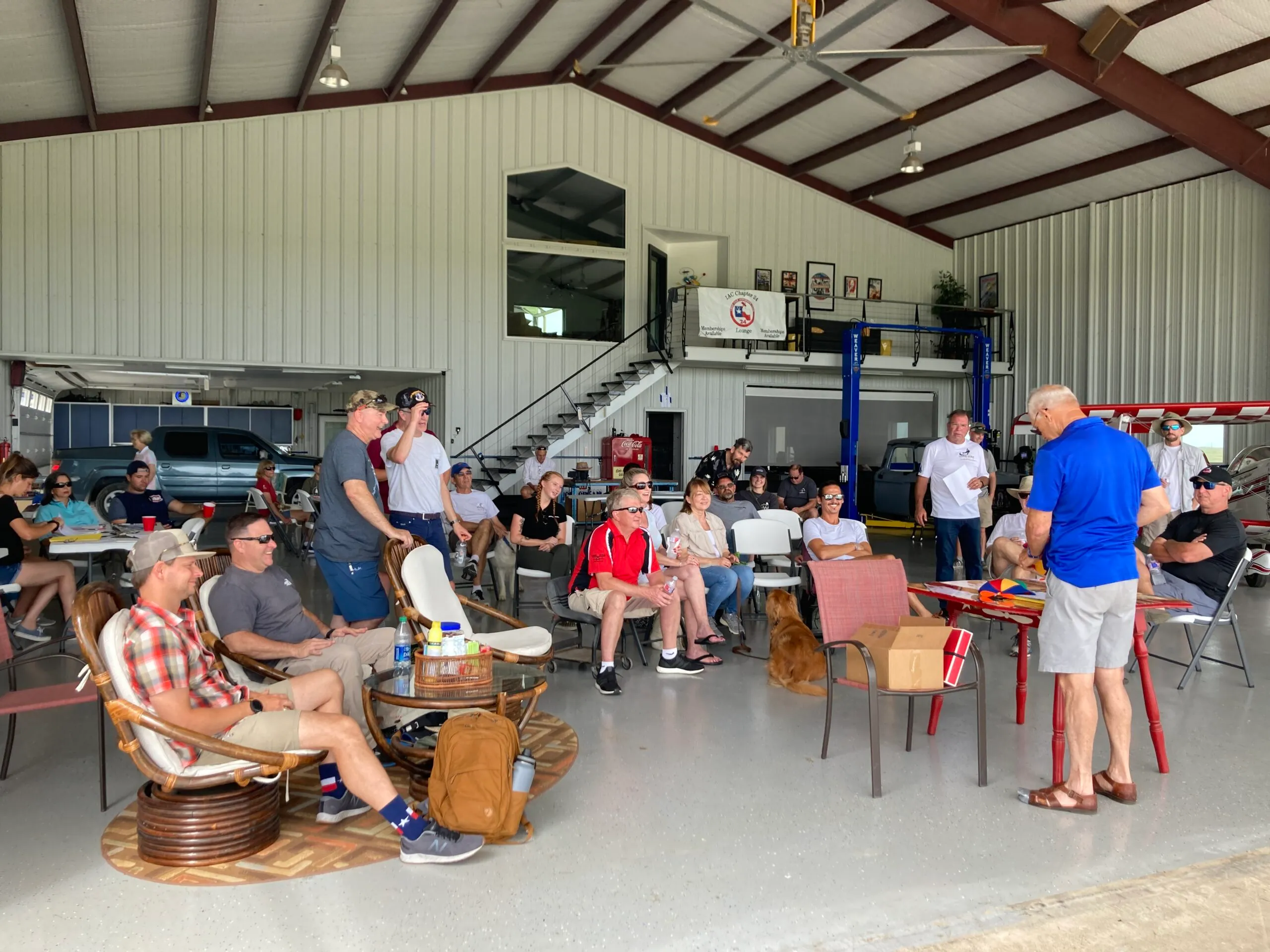 a group of people sitting, listening to a briefing