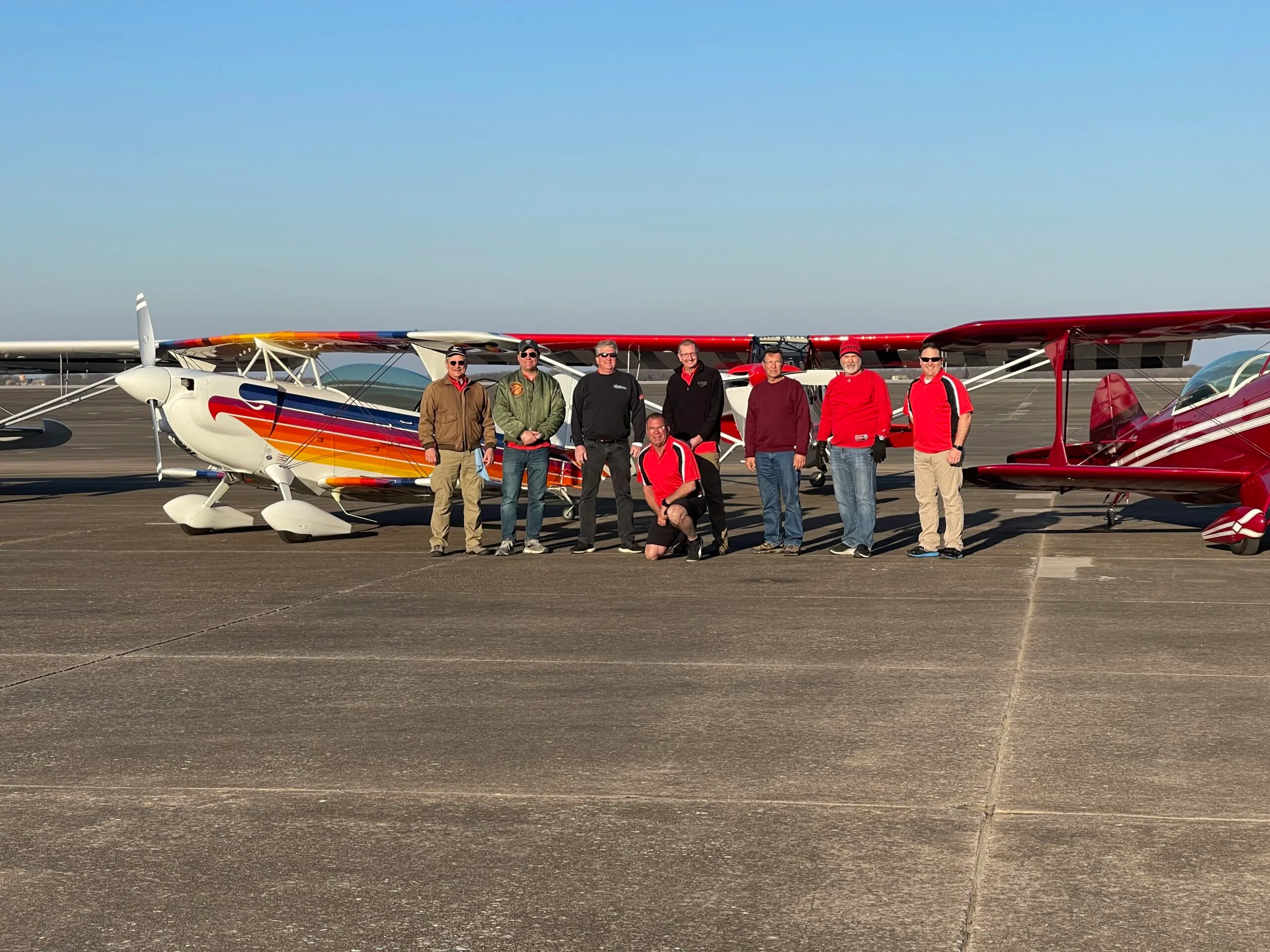 a group of people standing in front of an airplane