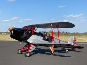 two people standing in front of a plane